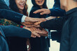 A group of diversity people putting their hands together. Showing unity teamwork and friendship. Close up side view of young business man and business woman joining as a team. Intellectual.