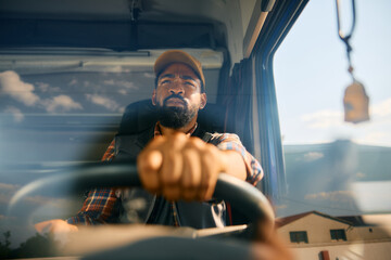 Close up of African American driver driving truck.