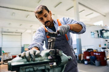 Wall Mural - Mid adult mechanic working at truck repair workshop.