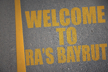 asphalt road with text welcome to Ra's Bayrut near yellow line.