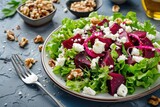 Fototapeta  - Healthy salad with beet, green mix lettuce, nuts, feta cheese