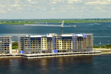 Wall Mural - Tower lifting cranes at high residential apartment buildings construction site. Real estate development