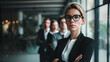 Portrait photo of Confident Female CEO Business Leader standing with arm crossed pose with Executive management Team in Background. Ambition businesswoman leadership concept.
