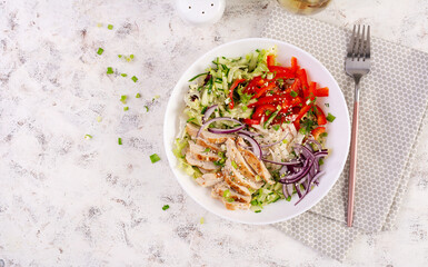 Wall Mural - Fresh  salad  with grilled chicken breast, fillet and lettuce, daikon, red onions, cucumber and sesame. Healthy lunch menu. Diet food. Top view