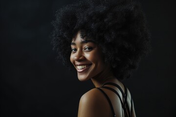 Wall Mural - Smiling young black woman with afro hairstyle in black dress.