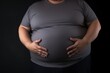 Fat man with overweight on black background, Close up of stomach and belly. Obesity Concept with Copy Space.