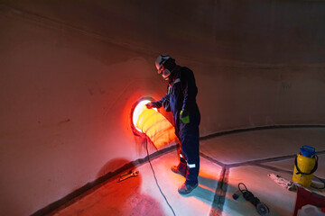 Wall Mural - Male worker inside the  tank storage visual inspection tank into the confined space is the blower