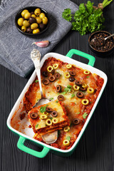 Wall Mural - lasagna with olive rings in green baking dish