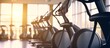 Elliptical in Modern gym interior with equipment. Row of training exercise bikes wheel detail