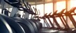 Elliptical in Modern gym interior with equipment. Row of training exercise bikes wheel detail