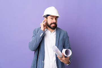 Wall Mural - Young architect man with helmet and holding blueprints over isolated purple background frustrated and covering ears