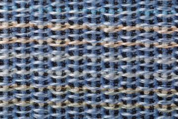 Blue nylon band with beige lines pattern in close up as background. The braiding of the net threads is clearly visible