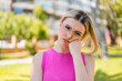 © luismolinero - Young pretty blonde woman at outdoors With glasses and with sad expression