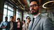 © Viorel Sima - confident leader man with glasses in suit posing in front of his team