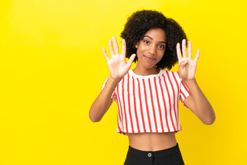 Wall Mural - Young African American woman isolated on yellow background counting nine with fingers