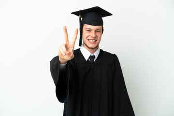 Wall Mural - Young university Russian graduate isolated on white background smiling and showing victory sign