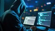 © Victoria - Hooded Figure Typing on a Computer at Night