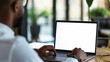 © Nuchylee - Over shoulder shot of a young man using computer laptop in front of an blank white computer screen in home