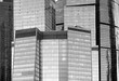 Dense standing high skrepper buildings of business area in retro style front view close up black and white photo