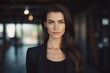 Young woman realtor with dark hair in business black suit, female entrepreneur, Closeup