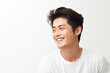 © Kitta Studio - Portrait of a handsome young man smiling while standing against white background