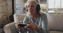 Home, controller and old woman play video game, fantasy RPG or digital interactive entertainment on lounge couch. Fun, gaming console and mature person with gamer challenge, competition or contest