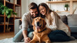 © Santy Hong - Happy Couple Play with Their Dog, Gorgeous Brown Labrador Retriever. Boyfriend and Girlfriend Tease, Pet and Scratch Super Happy Doggy, Have Fun in the Stylish Living Room.