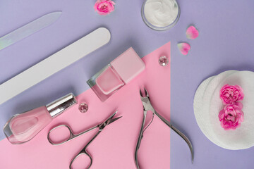 Wall Mural - Salon manicure concept photo. Manicure equipment with nail polish and rose petals pink background top view space for text