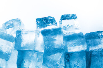 Ice cubes isolated white background,Natural crystal clear melting ice cubes on white reflective surface background. 