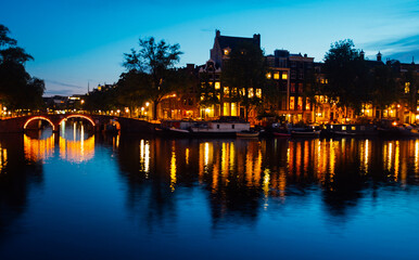 Wall Mural - Beautiful view of Amsterdam canals with bridge and typical dutch houses. Holland Amsterdam, Dutch canal house architecture . 