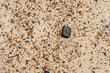 Background with metallic content stones on beach sand