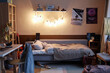© Seventyfour - Background image of teens room interior with comfortable unmade bed and posters on wall