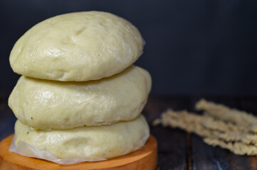 Canvas Print - Bapao is a steamed bun with savory or sweet filling. Peanut bakpao  on wooden plate. selected focus.