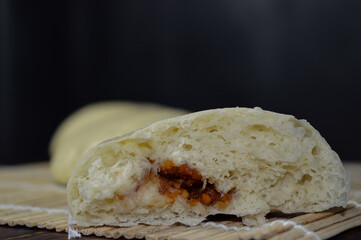 Sticker - Bapao is a steamed bun with savory or sweet filling. Peanut bakpao  on wooden plate. selected focus.