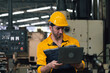 Caucasian engineer using a laptop in a factory. man working in plastics factory.