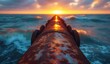 ice water from the oil pipeline running into the ocean, sunset