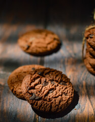 Poster - Stack of chocolate cookies on wooden table.