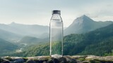 Fototapeta  - generic mineral glass water bottle in the middle of nature on a rock mockup with mountains background as wide banner with copy space area