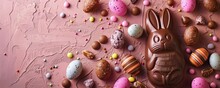Chocolate Easter bunny for children with different small sweets nearby for Easter celebration day, banner with copy space