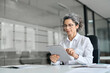 © insta_photos - Busy middle aged professional business woman using tab computer in office. Mature senior businesswoman bank manager, older female corporate executive holding digital tablet sitting at work desk.