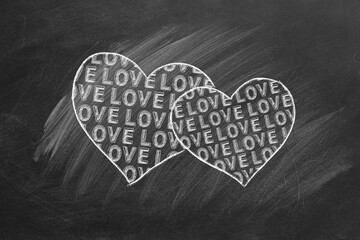 Two hearts with lettering LOVE inside. Chalk drawn illustration. Valentines Day, wedding.