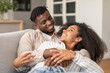 © Prostock-studio - Loving Millennial Black Spouses Hugging And Cuddling While Relaxing Indoors