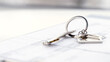 © I - a key with a keychain house on the contract of sale of housing