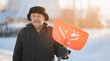 © Parilov - Elderly man cleaning snow with shovel after snowstorm. Worker old pensioner works as janitor, sunlight.