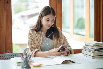 Wall Mural - Self learning concept. Young woman student wear headphone listening lesson in the university.