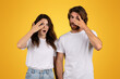 © Prostock-studio - Shocked and curious couple with wide eyes covering one eye with their hands