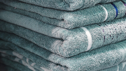 Leinwandbilder - Stack of turquoise terry towels on a shelf