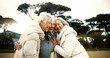 © Clement C/peopleimages.com - Talking, laughing and elderly woman friends outdoor in a park together for bonding during retirement. Happy, smile and funny with a group of senior people hugging in a garden for humor or fun