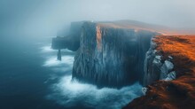  A Large Rock Formation In The Middle Of A Body Of Water With A Lighthouse On Top Of It In The Middle Of A Foggy Day.