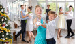 © JackF - Couples dancing - teenagers in festive clothes dance the Viennese waltz near the Christmas tree